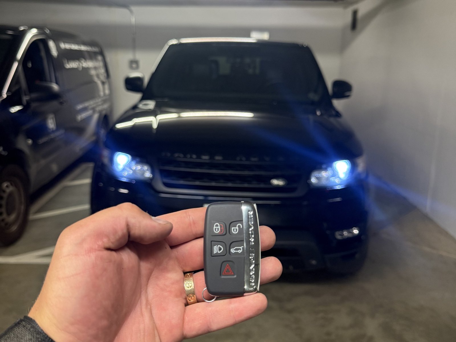 Range Rover Sport in a Vancouver parkade with a hand holding its smart key
